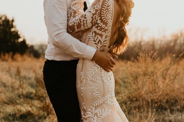 A bride wearing a boho lace wedding dress made with luxury embroidered bold lace.