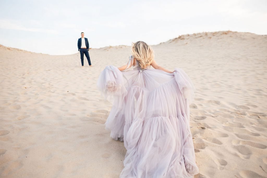  Elsa is a couture gown made by a designer in Germany, with soft tulle in a light blue color with ribbons dropping from the shoulder and a gorgeous train. Worn by bride in the sand dunes