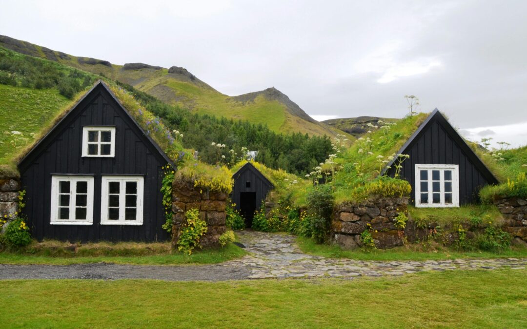 photo of cottages in the Faroe Islands that have green moss or grass for a roof, a unique romantic stay