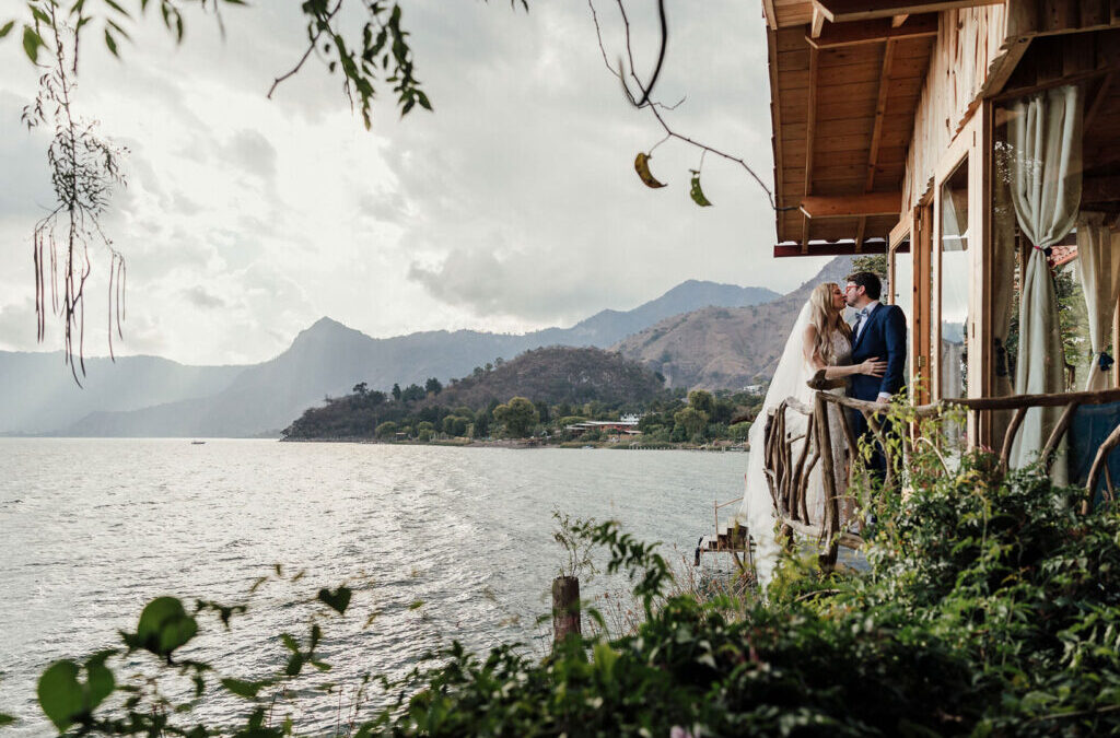 Guatemala elopement, a bride and groom embracing on a deck of a house on Lake Atitlán